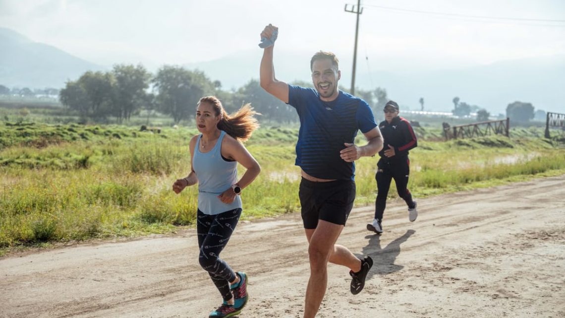 Group of people enjoying a morning run on a rural trail, embracing fitness and vitality.
