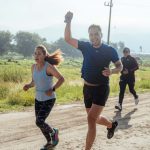 Group of people enjoying a morning run on a rural trail, embracing fitness and vitality.
