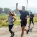Group of people enjoying a morning run on a rural trail, embracing fitness and vitality.